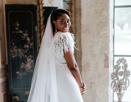 bride wearing wedding dress with feather and paillette embellishments 