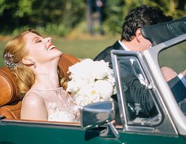 Bride and groom driving away from wedding