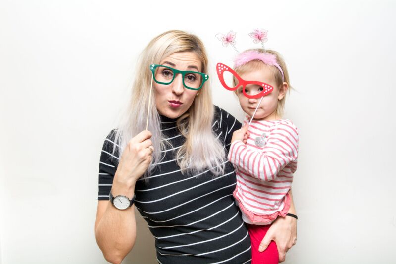 mom and toddler with photo booth props