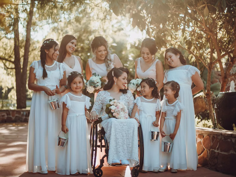Junior bridesmaids surround the bride and bridesmaids at a wedding. 