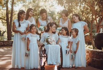 Junior bridesmaids surround the bride and bridesmaids at a wedding. 