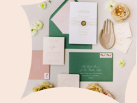 Green and pink wedding invitation envelopes spread with flowers