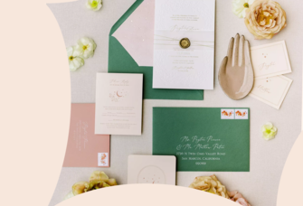 Green and pink wedding invitation envelopes spread with flowers