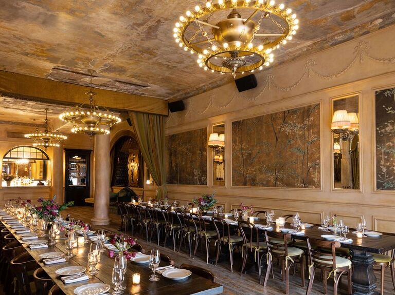 Enchanting reception space with marble walls, gold chandeliers and wooden flooring