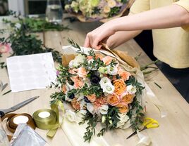 Woman making beautiful floral arrangement online flower gift delivery service