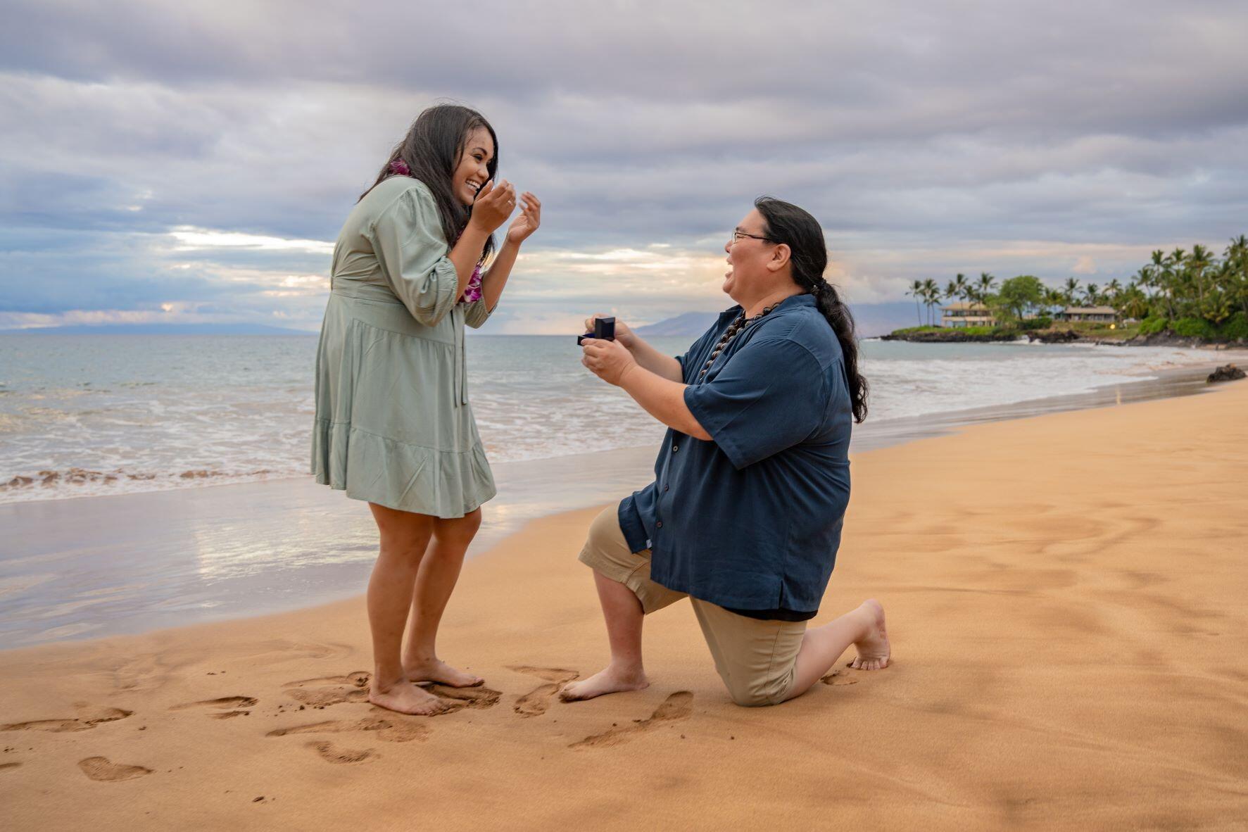 Stephanie got the surprise of her life when while having professional photos taken with Steve on Po'olenalena Beach, Steve got down on one knee and proposed to her.