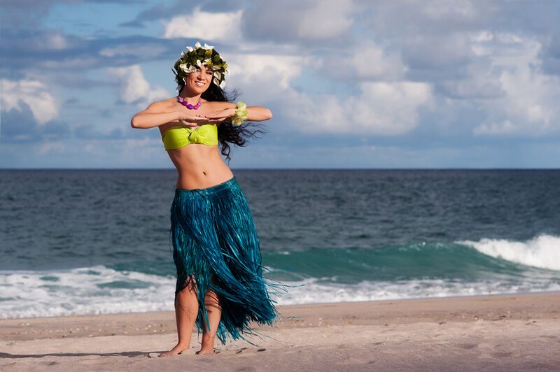 Dancer in blue hula skirt on the beach