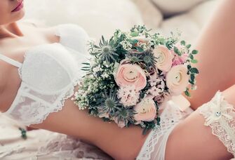 Bridal boudoir photo shoot with a bouquet