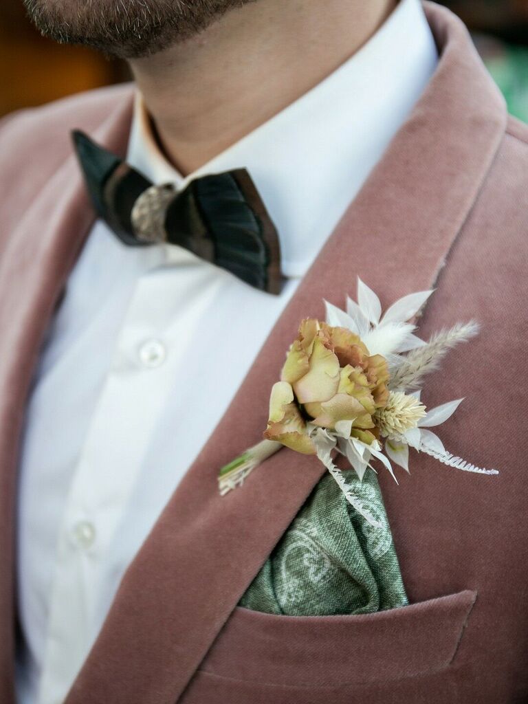 Pale pink jacket with golden and green boutonniere