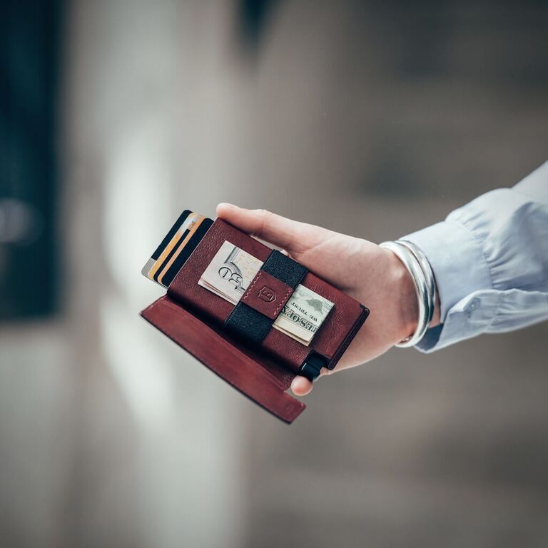 Man holding red wallet and card holder